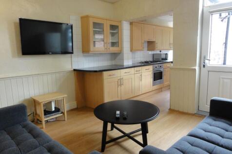Bright open-plan living area with two comfortab...