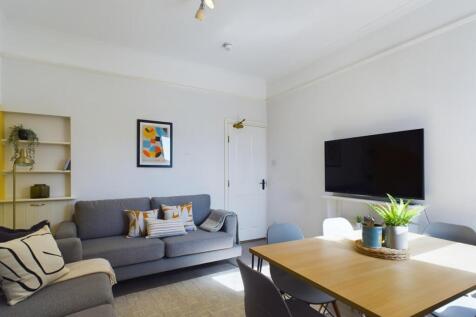 A modern, bright living room featuring a large ...