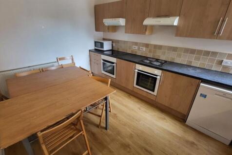 Modern fitted kitchen with wood-effect cabinets...