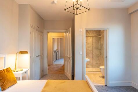 Bright, freshly decorated master bedroom with a...