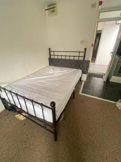 Comfortable double bed in a bright bedroom...