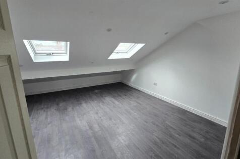 Spacious loft bedroom with bright skylights...