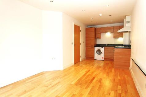 Modern open plan kitchen with sleek wood floors...
