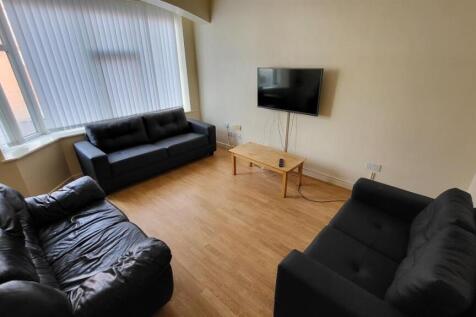 Bright living room with large front window, thr...