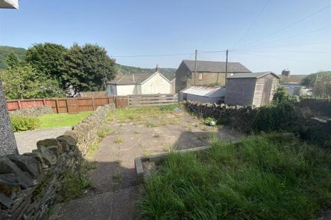 Spacious sunny garden with scenic stone walls...