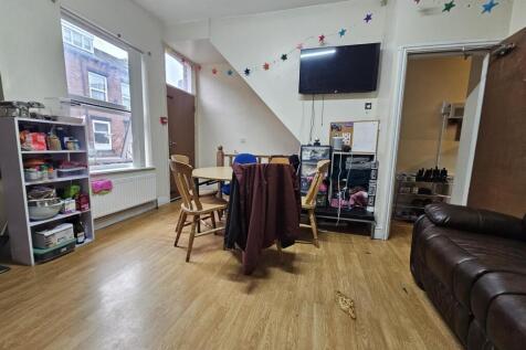 A bright and welcoming living room featuring a ...
