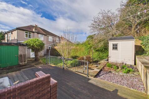 North East facing garden with a mixture of grass, decking and flagged areas