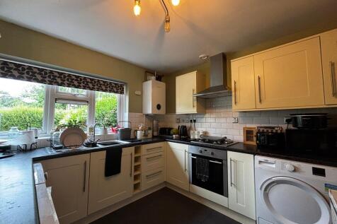 Bright kitchen with modern appliances and garde...