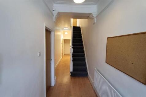 Bright, clean hallway with wood-look flooring...