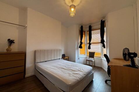 Bright and spacious bedroom with study desk are...