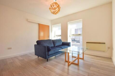 Bright and modern living room with plush seatin...