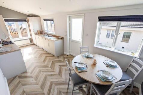 Dining Area With Modern Kitchen And Large Windows
