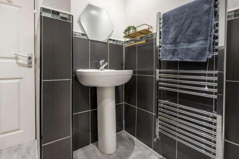 A modern and tidy bathroom featuring stylish fi...