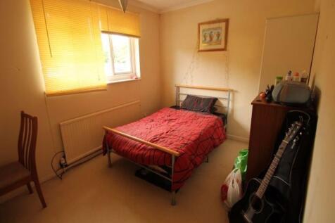 Warm, tidy double bedroom with a metal bed fram...