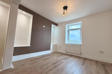 Modern room with feature wall and wood flooring...