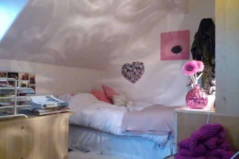 A cozy and inviting bedroom featuring a comfort...