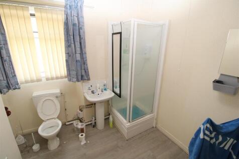 Bright bathroom with a walk-in shower and windo...