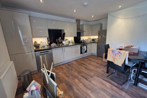 Bright modern kitchen with glossy fitted cabine...