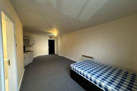 Spacious living area featuring a large open spa...