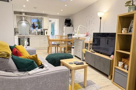 Bright, modern open-plan living area with comfo...