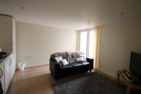 A bright and spacious living room featuring a c...