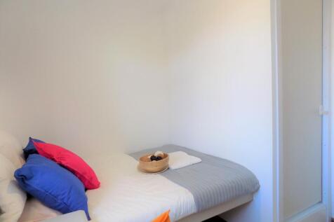 Bright, simply furnished single bedroom with a ...