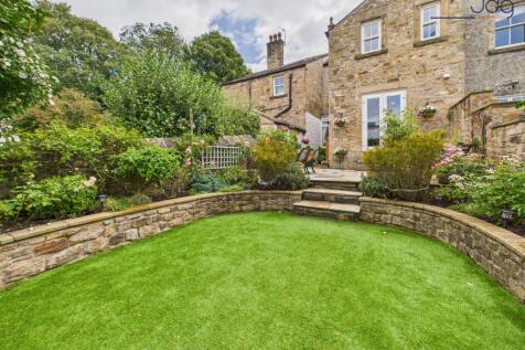 Rear view of the property and gardens