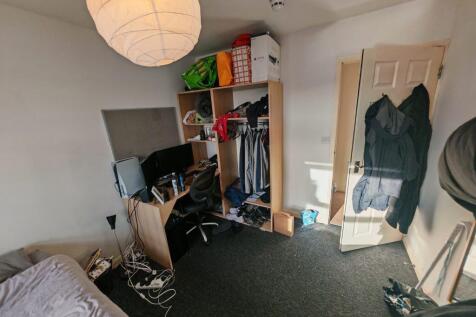 Bright bedroom with integrated desk and storage...