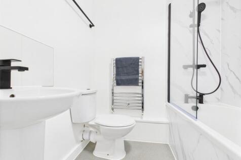 Bright, modern bathroom with white sanitaryware...