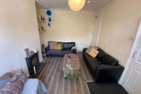 A spacious, well-lit living room featuring mode...