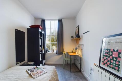 A bright and inviting double bedroom featuring ...