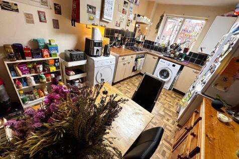 Warm, well-equipped kitchen with wooden worktop...