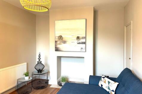 A bright and stylish living room featuring a mo...