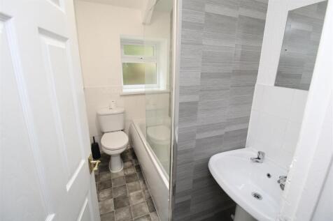 Modern bathroom with stylish tiles and bathtub...