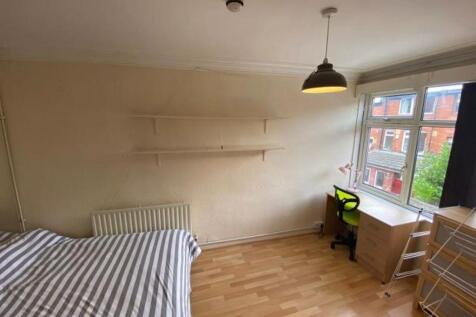 Bright and airy bedroom featuring a large windo...