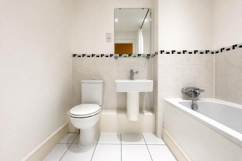 Clean contemporary bathroom suite with full bat...