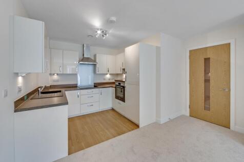 a kitchen with white cabinets