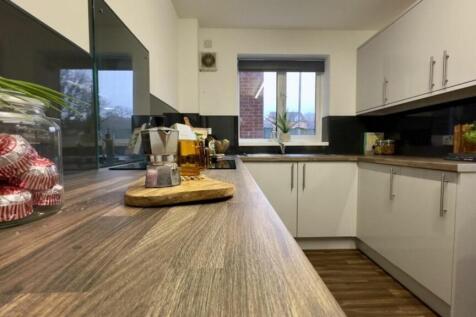 A bright and modern kitchenette with ample spac...