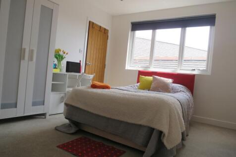 A bright and inviting double bedroom with moder...