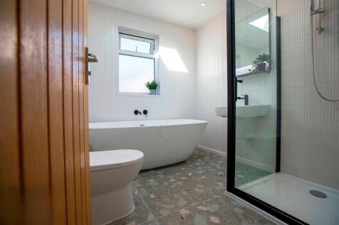 Bright modern bathroom with freestanding bath...