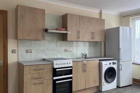 Bright kitchen with modern appliances and stora...