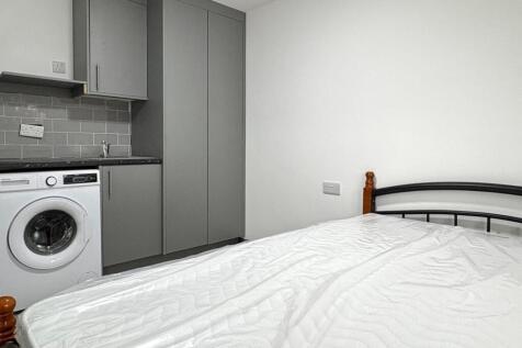 Neat bedroom with a comfortable double bed, bui...