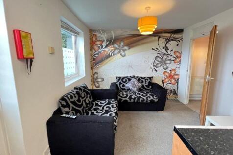 Bright lounge with stylish floral feature wall...