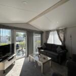 Bright Lounge With Patio Doors Opening Onto The De