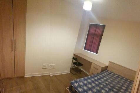 Neat furnished bedroom with wooden flooring, bu...