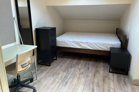 Modern attic room with desk and sleek furniture...