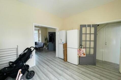 Bright, clean kitchen area with light wood-effe...