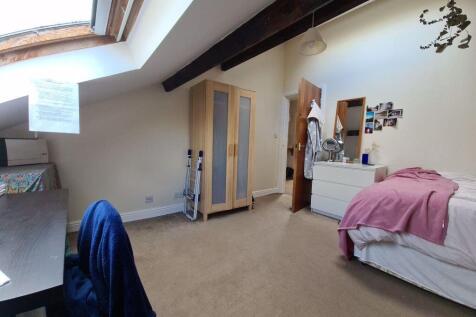 Bright double bedroom with a sloped skylight, e...