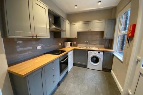 Contemporary fitted kitchen with grey shaker ca...
