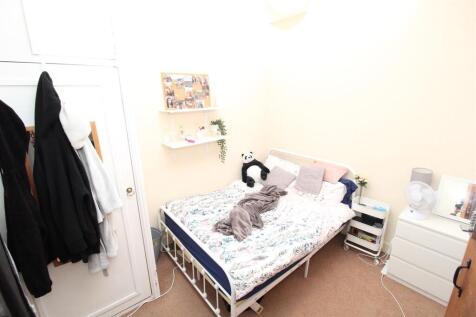 Bright bedroom with double bed and ample storag...